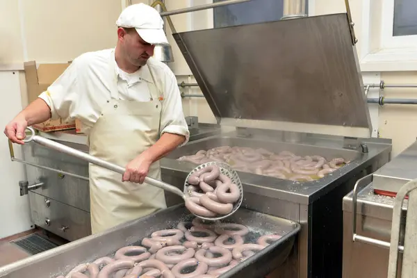 Man Taking Cooked Sausages Cauldron Butchery — Stock Photo, Image