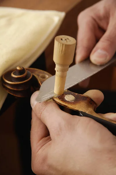 Craftsman using knife for making violin — Stock Photo, Image