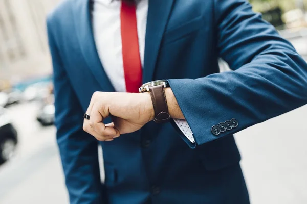 Cropped image of businessman looking on watches — Stock Photo