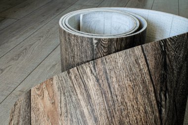 Roll of linoleum with a wood texture. Types of floor coverings.  clipart
