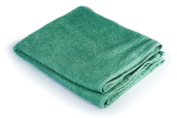 Зеленое полотенце на белом — стоковое фото