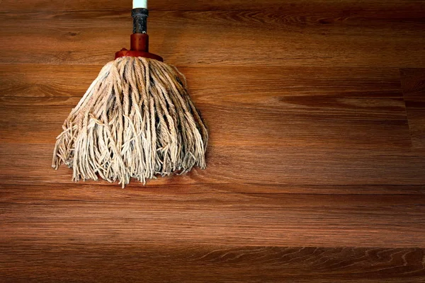 Cleaning brown parquet with mop — Stock Photo, Image