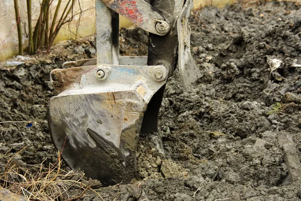 Een oude Sovjet-Unie trekker graaft en ladingen afvalstoffen steen verwerking in de buurt van — Stockfoto