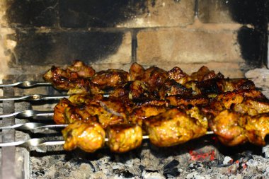 Şiş kebap şişleri ve ahşap kömürlerin üzerinde pişmiş
