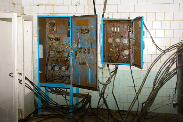 Old dismantled and rusty electrical panel assembly on an abandon