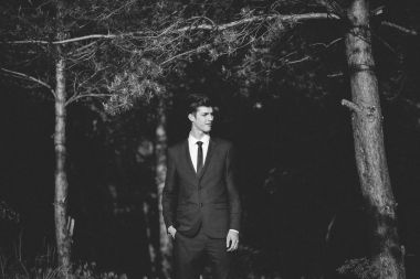 Ormanda poz takım elbiseli adam