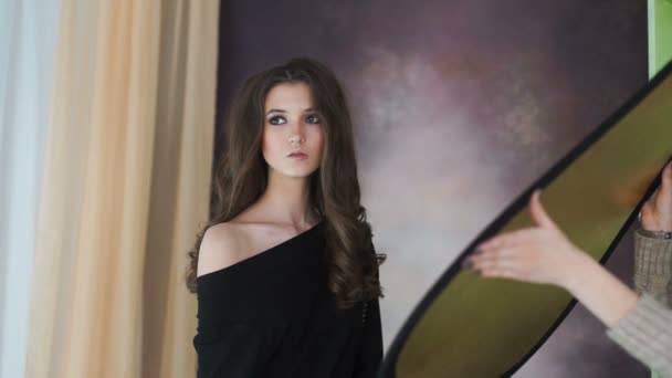 Beautiful model posing on photosession in studio. — Stock Video