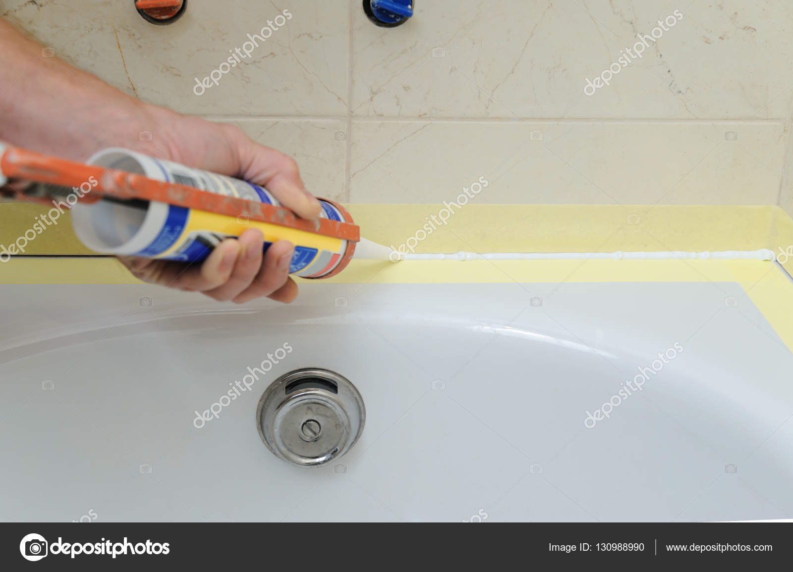 Worker puts silicone sealant. Stock Photo by ©Yunava1 130988990
