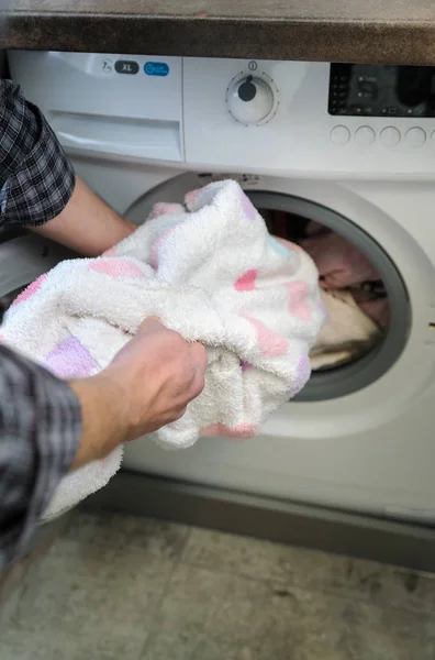 Hand man takes things  with the washing machine. — Stock Photo, Image