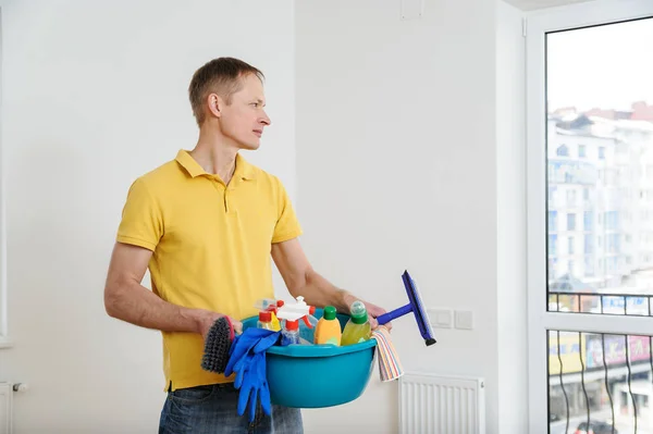 The man cleans the house.