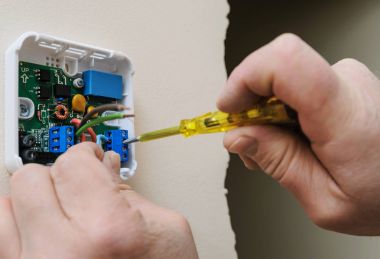 Installing a programmable room thermostat. clipart