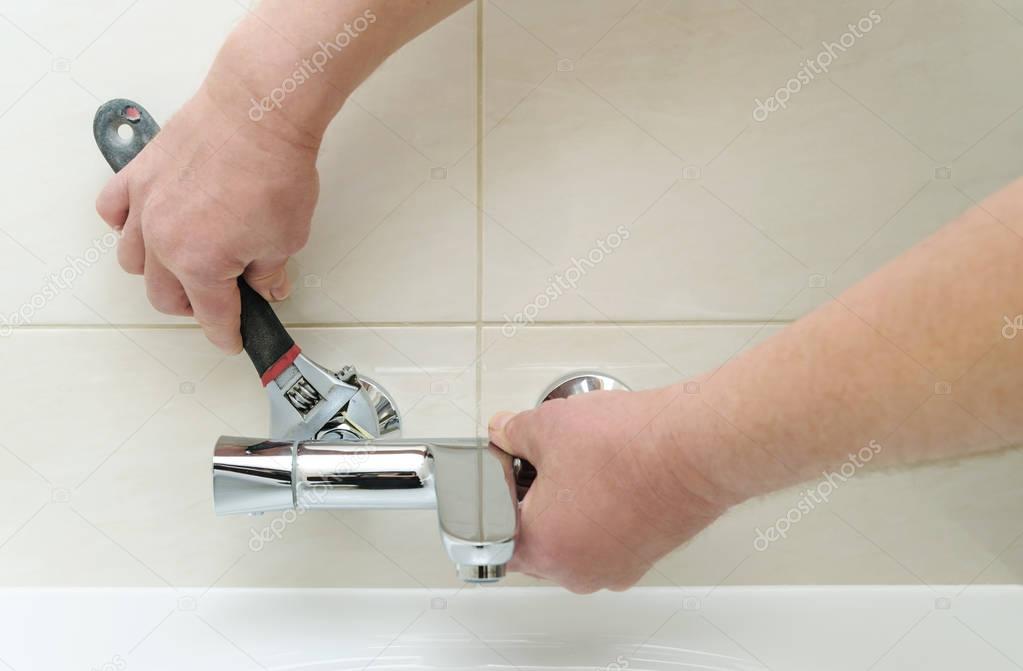 Installing faucet with thermostat.