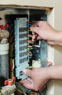 Switching signal wires in the home's heating system control. clipart