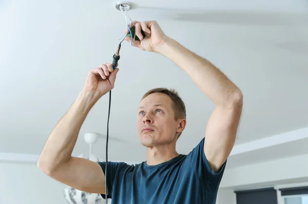 Installing a spotlight in the room. — Stock Photo, Image