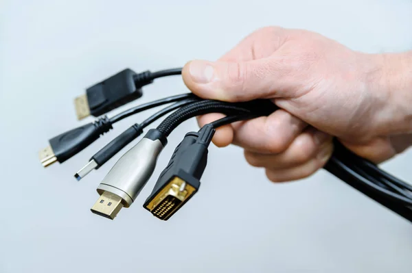 The  various cords and plugs in the hand. — Stock Photo, Image