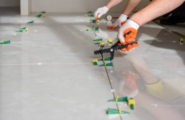 Installing a large ceramic tile. clipart