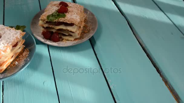 Raspberry Mille-feuille with cinnamon on a blue wooden Board — Stock Video