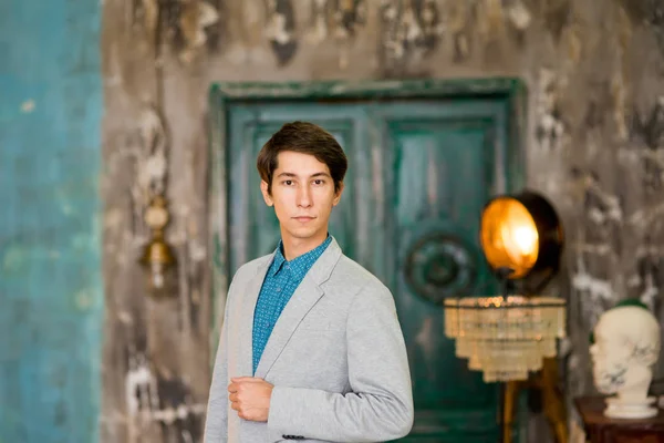 Young handsome man in a stylish grey blazer — Stock Photo, Image