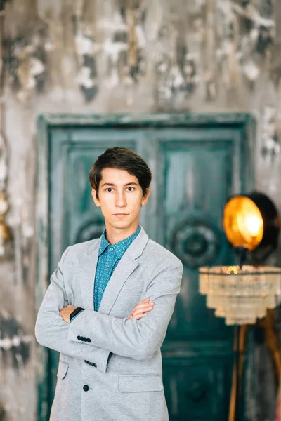 Joven hombre guapo en una elegante chaqueta gris — Foto de Stock