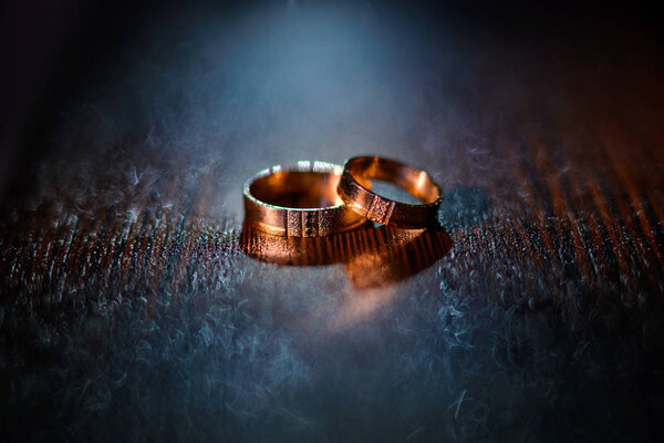 Wedding rings with water droplets against