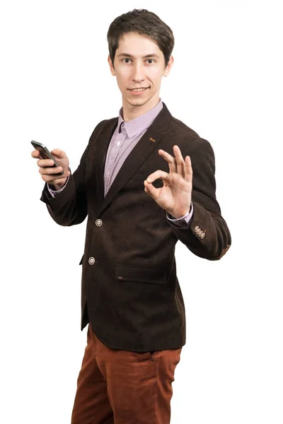 Empresario con un teléfono hace un gesto de OK  . — Foto de Stock
