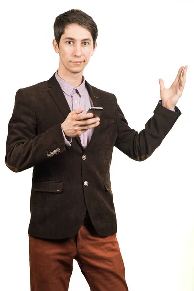 Young successful happy businessman with mobile telephone or smartphone points a finger up — Stock Photo, Image