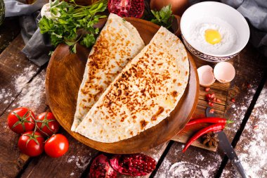 Azerbaycan ulusal mutfağı bir tabakta kutabs ile ayırt edilir. Üst görünüm ve tahta arkaplan