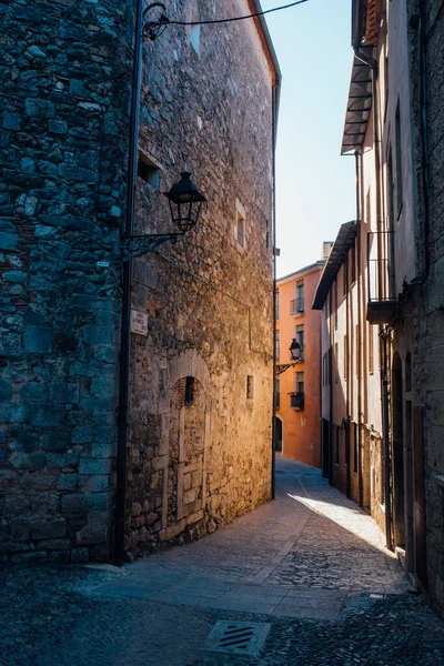 Medieval streets of Girona. Medieval alley with stone walls in Girona.