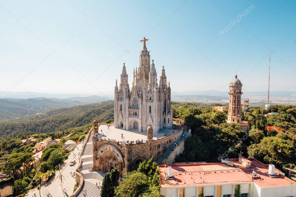 Tibidabo church on mountain in Barcelona with christ statue overviewing the city