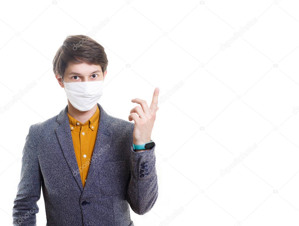 A recovered man in a medical mask, shirt, gestures at an empty background