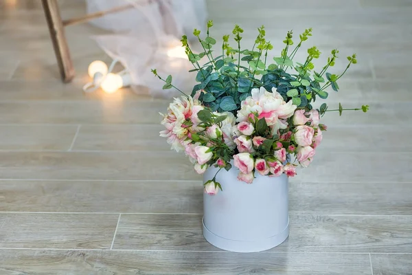 Bouquet of white jasmine flowers in a vase. Romantic floral still life with white jasmine flowers and petals. Mock orange jasmine - Philadephus flowers. Home flower decoration.