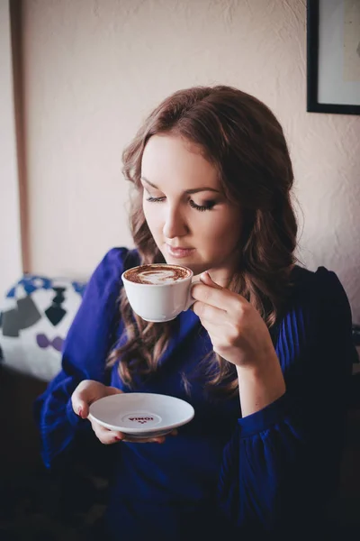 Diwa angel mystic lady woman wearing casual blue dress lonely sitting in restaurant caffe with coffe cup awaiting her boyfreind husband in beautiful dreams with happy end.Tender scene of love story