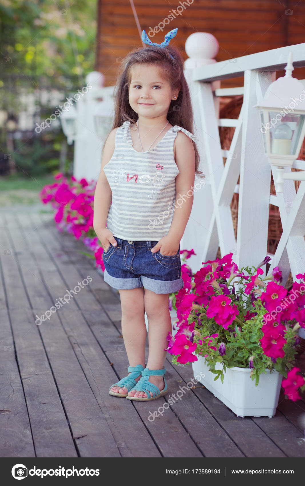 Stylish beautifull cute baby girl with brunette hair posing on ...