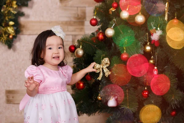 Asiático menina bonito vestindo vestido casual posando perto de ano novo Natal árvore clássica verde com bolas brinquedos e coloridos presents.Happy feriados com Papai Noel e criança criança — Fotografia de Stock