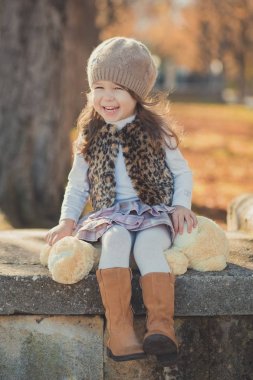Pin-up çekici genç esmer kızı giyiyor moda şık gri ceket umut ve giyim Sonbahar Bahar park hafta sonu happyly gülümseyen oturma yolu poz izlemek harika bot ile sıcak şapka dolly.