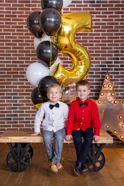 Güzel çocuk, doğum günü kutluyor ve mum ev yapımı üzerinde üfleme küçük çocuklar, kapalı pasta. Kardeşler çocuklar için doğum günü partisi. Hediyeler ve frirework mutlu İkizler