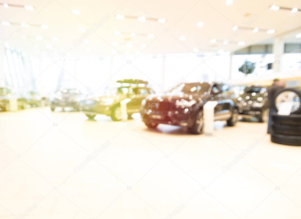 Blurred dealership store, with the cars and soft lightning