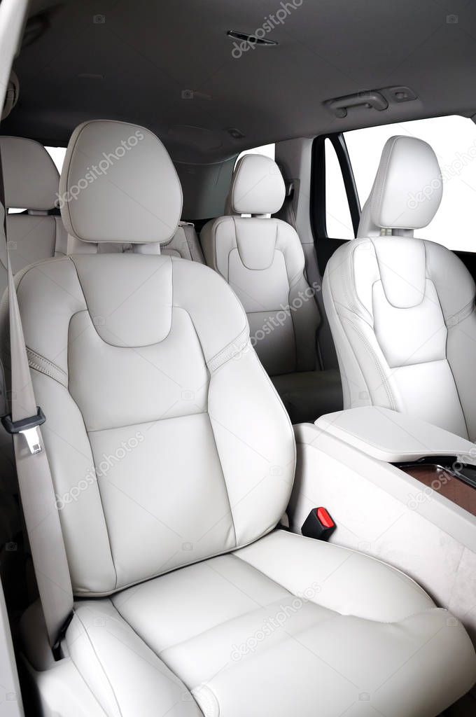 Luxury car inside. Interior of prestige modern car. Comfortable leather seats. White leather cockpit with isolated white background.