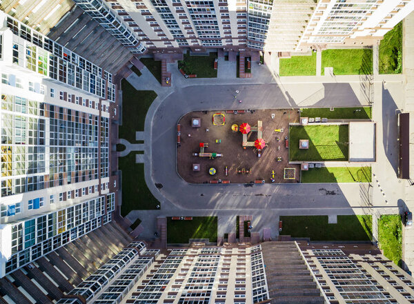 Bird-eye view of the playground kids in a residential complex in sunny day