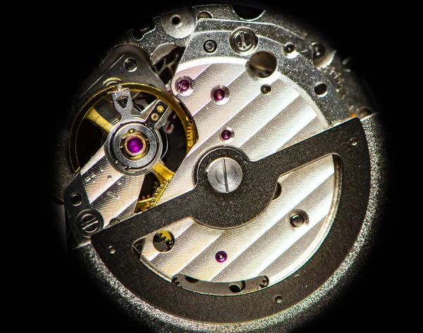 Mechanism, clockwork of a watch with jewels, close-up. Vintage background. Time, work concept.