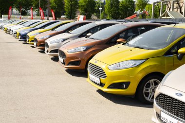 Riga, Letonya - 15 Mayıs 2018: Riga Letonya 'da gündoğumunda mavi gökyüzüne karşı satılık yeni arabalar.