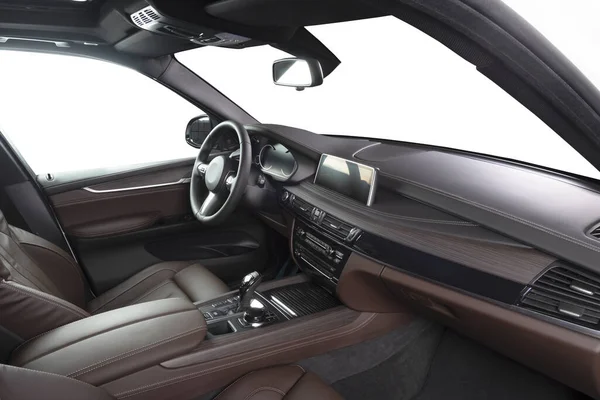 Orange red sand leather luxury car inside Interior - steering wheel, shift lever and dashboard.