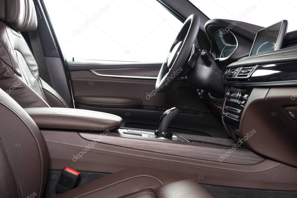 Red leather luxury car inside Interior - steering wheel, shift lever and dashboard. 