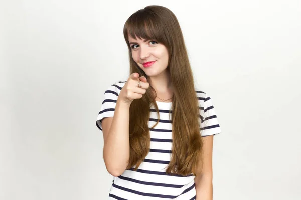 Woman pointing at camera with index finger