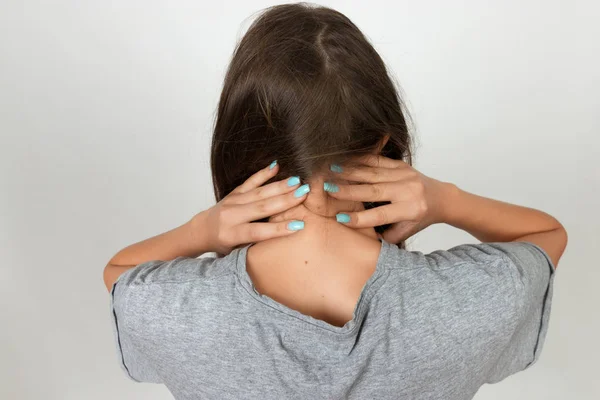 Retrato de una mujer bonita sosteniendo su cuello con dolor e incomodidad. Concepto de dolor de cerca — Foto de Stock