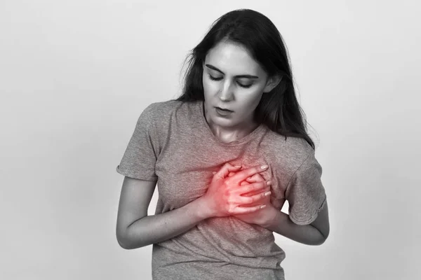 Beautiful female  with heart attack or broken heart. Black and white with red accent