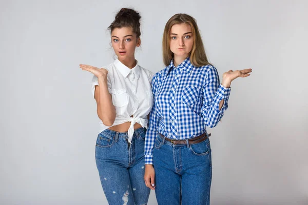 Portrait Two Young Sisters Presenting One Hand Standing Gray Background — Stock Photo, Image