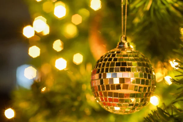 blurred sparkle ball hang on the christmas tree with bokeh background