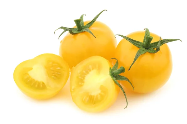 Fresh dutch yellow "tasty tom" tomatoes and a cut one — Stock Photo, Image