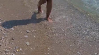 Kumsalda genç bir kadının tabaklanmış bacaklarım